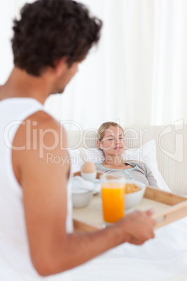 Man bringing the breakfast to his wife