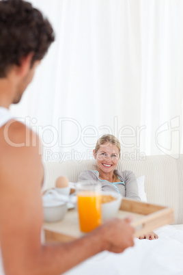 Man bringing the breakfast to his wife