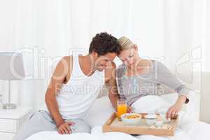 Lovers having breakfast at bed