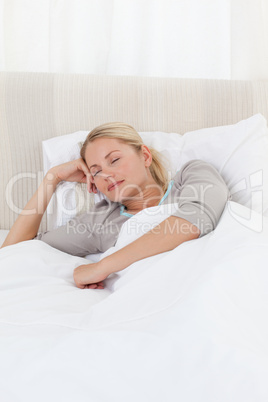 Peaceful woman sleeping in her bed at home