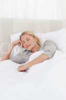 Peaceful woman sleeping in her bed at home