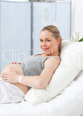 Pregnant young woman on a hospital bed