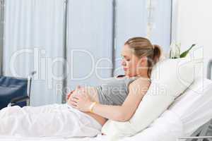 Pregnant young woman on a hospital bed