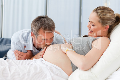 Man kissing his wife's belly