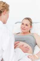 Nurse reassuring her pregnant patient