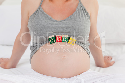 Pregnant woman with baby cubes on her belly