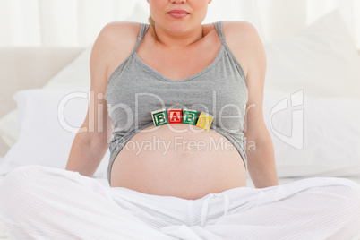 Pregnant woman with baby cubes on her belly