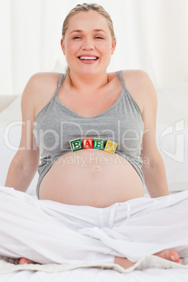 Pregnant woman with baby cubes on her belly