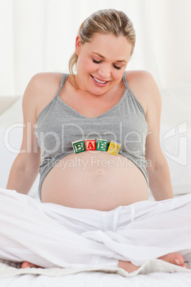 Pregnant woman with baby cubes on her belly