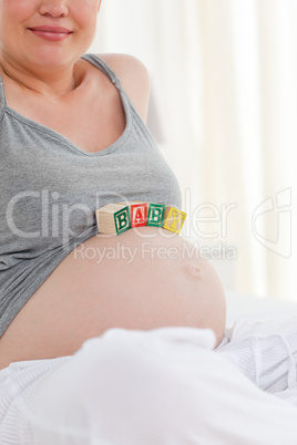 Pregnant woman with baby cubes on her belly