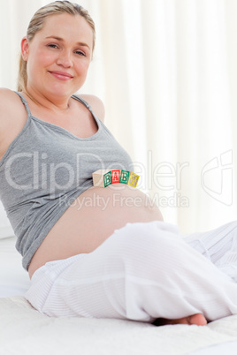 Pregnant woman with baby cubes on her belly