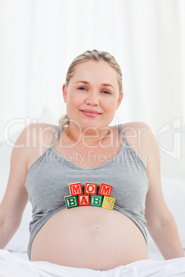 Pregnant woman with baby cubes on her belly