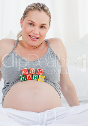 Pregnant woman with baby cubes on her belly