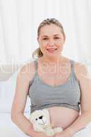 Pregnant woman with a cuddly toy