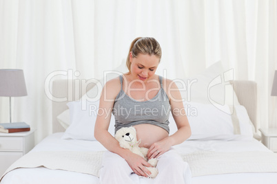 Pregnant woman with a cuddly toy