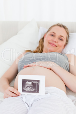 Delighted pregnant woman with her X-ray