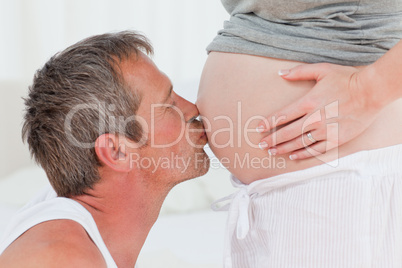 Man kissing his wife's belly