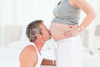 Man kissing his wife's belly