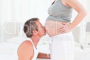 Man kissing his wife's belly