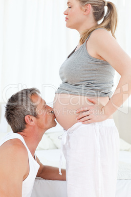 Man kissing his wife's belly