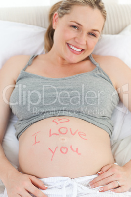 Pregnant woman with a love word on her belly
