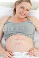 Pregnant woman with a love word on her belly
