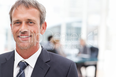 Smiling businessman in his office