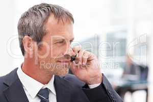 Businessman phoning in his office