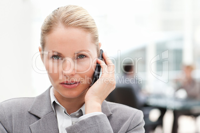Lovely woman phoning in her office