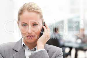 Lovely woman phoning in her office