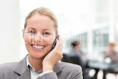 Lovely woman phoning in her office