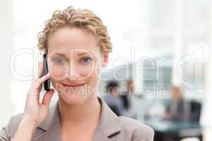 Beautiful businesswoman phoning in her office