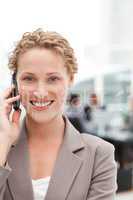 Beautiful businesswoman phoning in her office