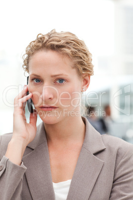 Beautiful businesswoman phoning in her office Beautiful businesswoman phoning in her office
