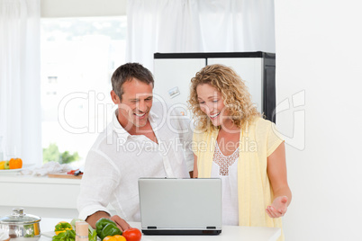 Young couple looking at their laptop
