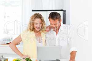 Young couple looking at their laptop