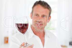 Man with his wineglass in his kitchen