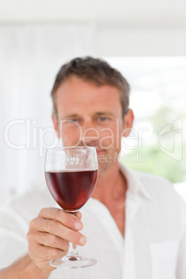 Man with his wineglass in his kitchen