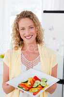 Woman showing her healthy food  in her kitchen