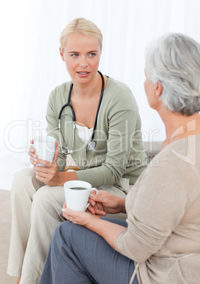 Doctor drinking with her patient