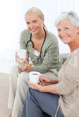 Doctor drinking with her patient