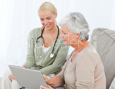 Senior with her doctor working on the laptop