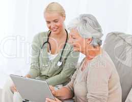 Senior with her doctor working on the laptop