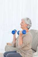 Senior doing her exercises on her sofa