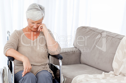 Thoughtful senior in her wheelchair