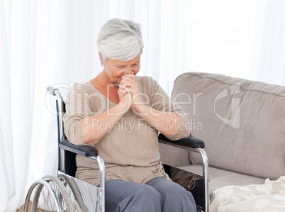 Thoughtful senior in her wheelchair