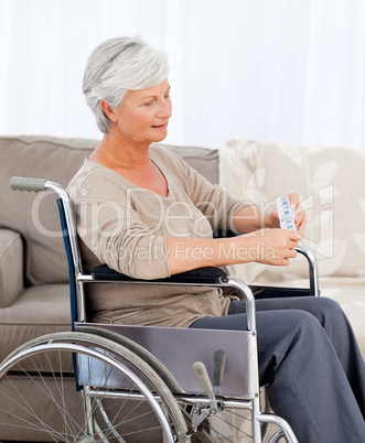 Senior in wheelchair with pills