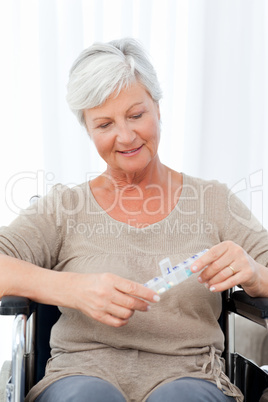 Senior in wheelchair with pills