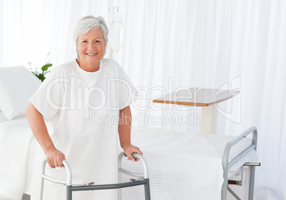 Senior woman looking at the camera with her zimmer frame