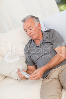 Senior with pills at home